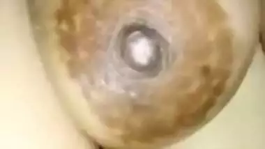 Indian slut sits in front of camera happily baring saggy XXX boobs