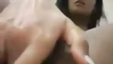 An Indian nude girl fingers her shaved pussy and ass